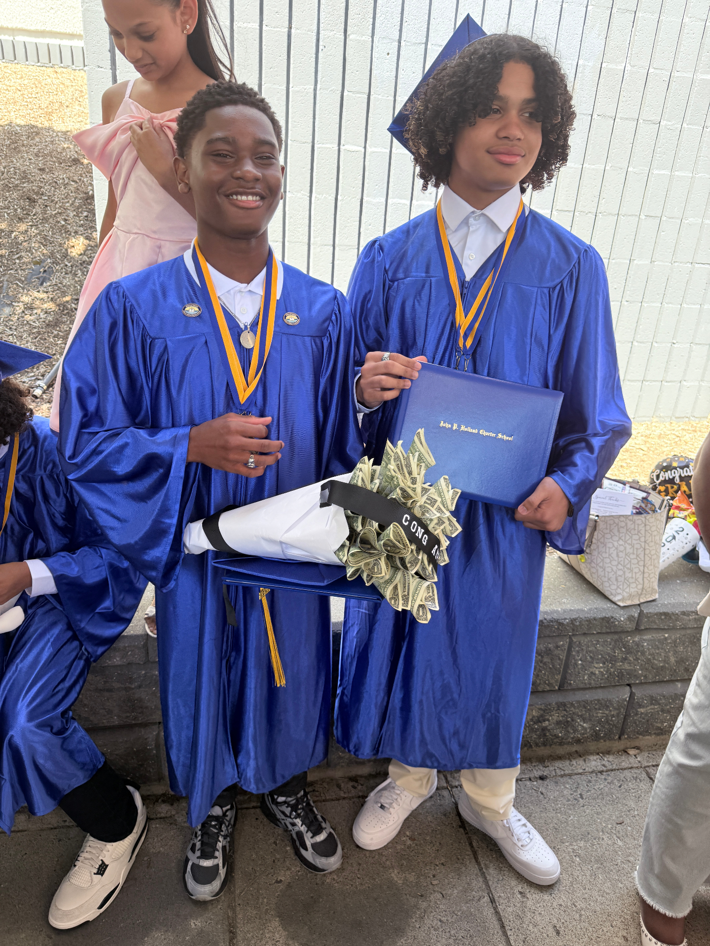 Zadon with classmate holding money bouquet