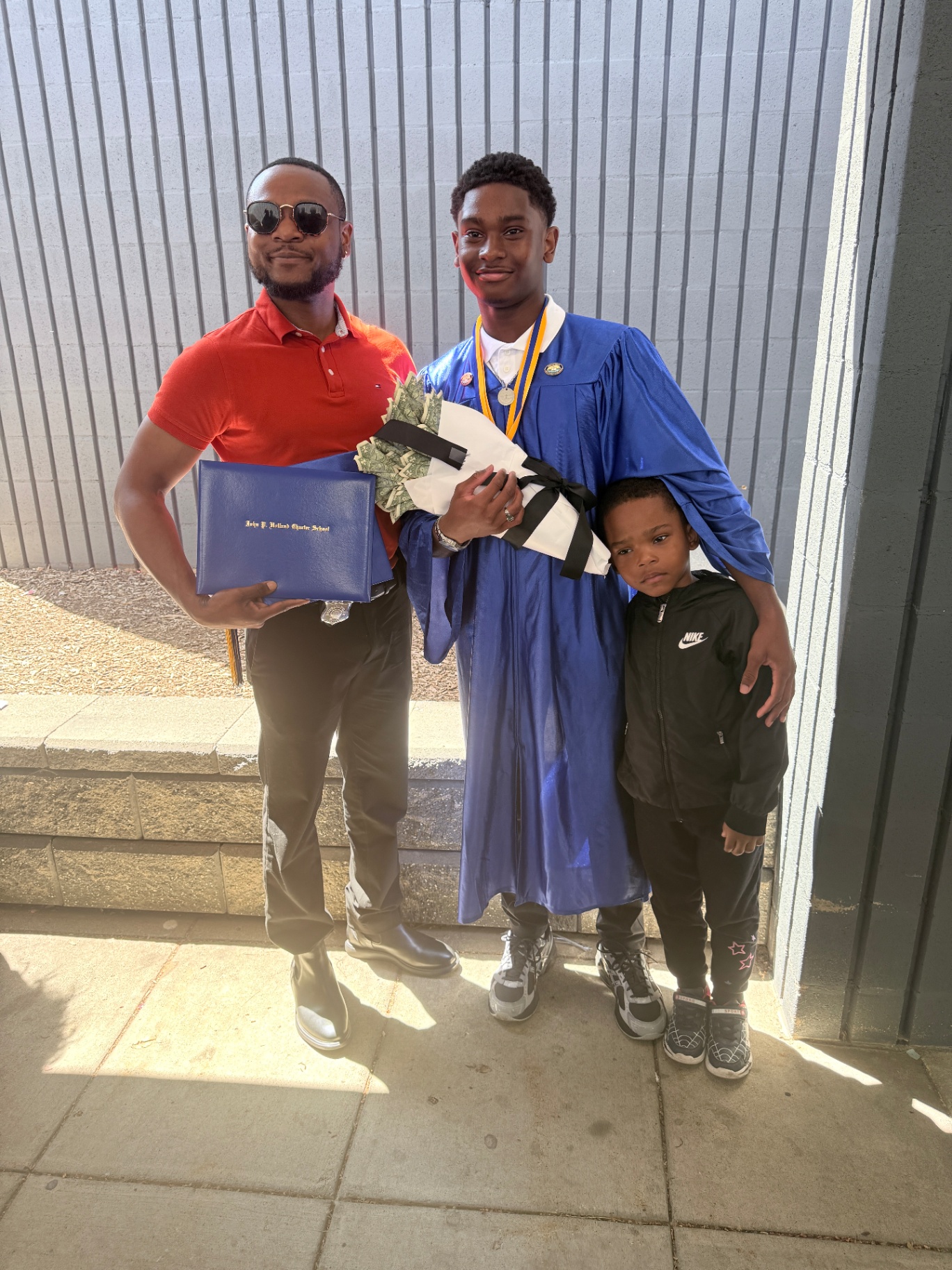 Zadon with dad and little brother — diploma in hand
