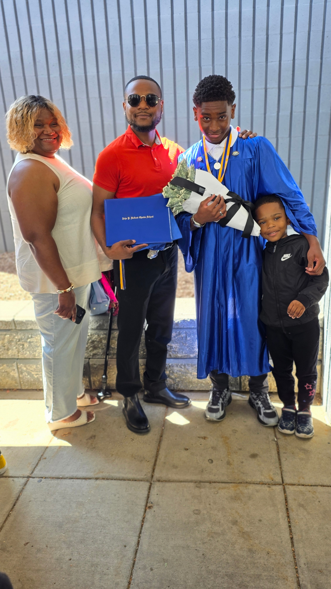 Zadon with family — diploma in hand