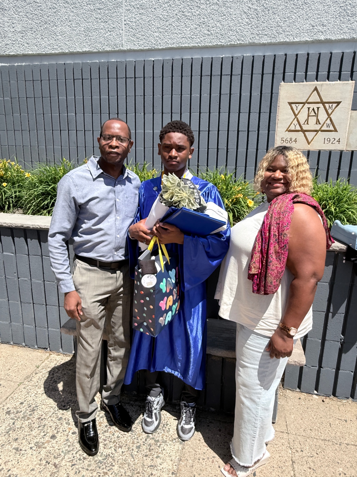 Zadon flanked by mom and dad after the ceremony